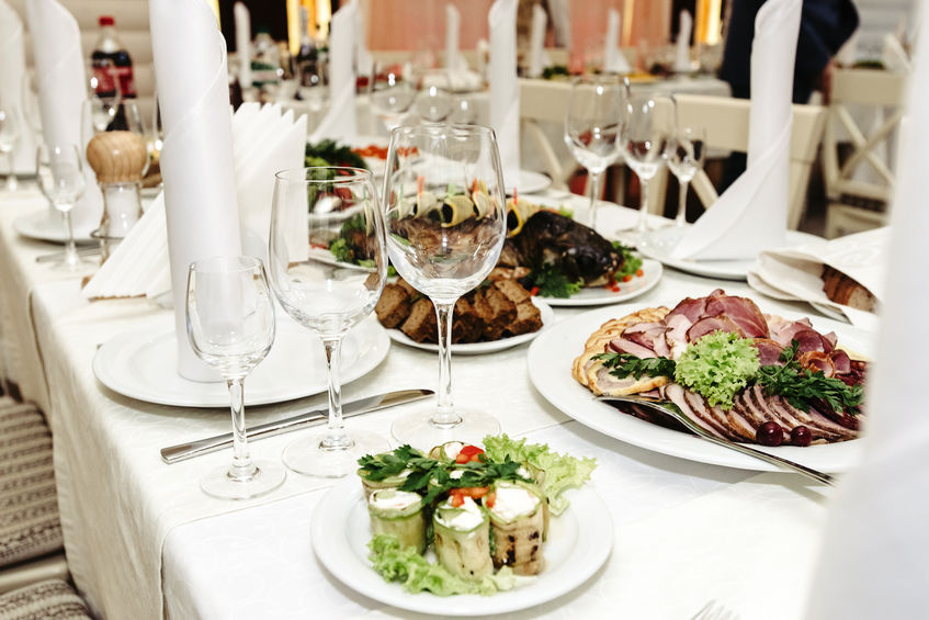 stylish fashionable decorated table with glasses and delicious food, celebration wedding, catering in the restaurant