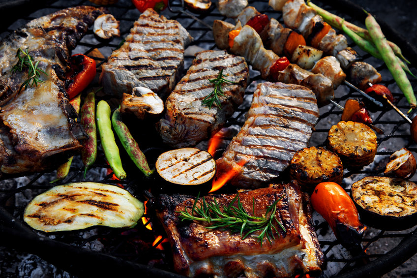 Grilled meat and vegetables on barbecue kettle